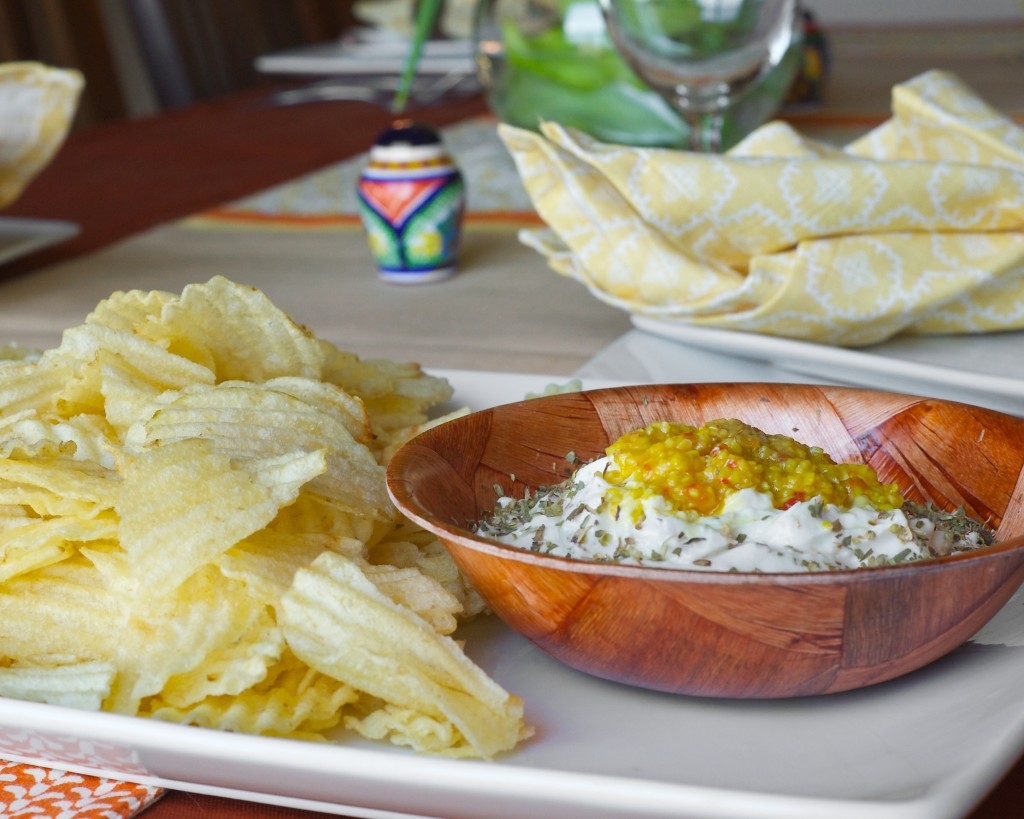 yogurt dip with species and garlic served with potato chips