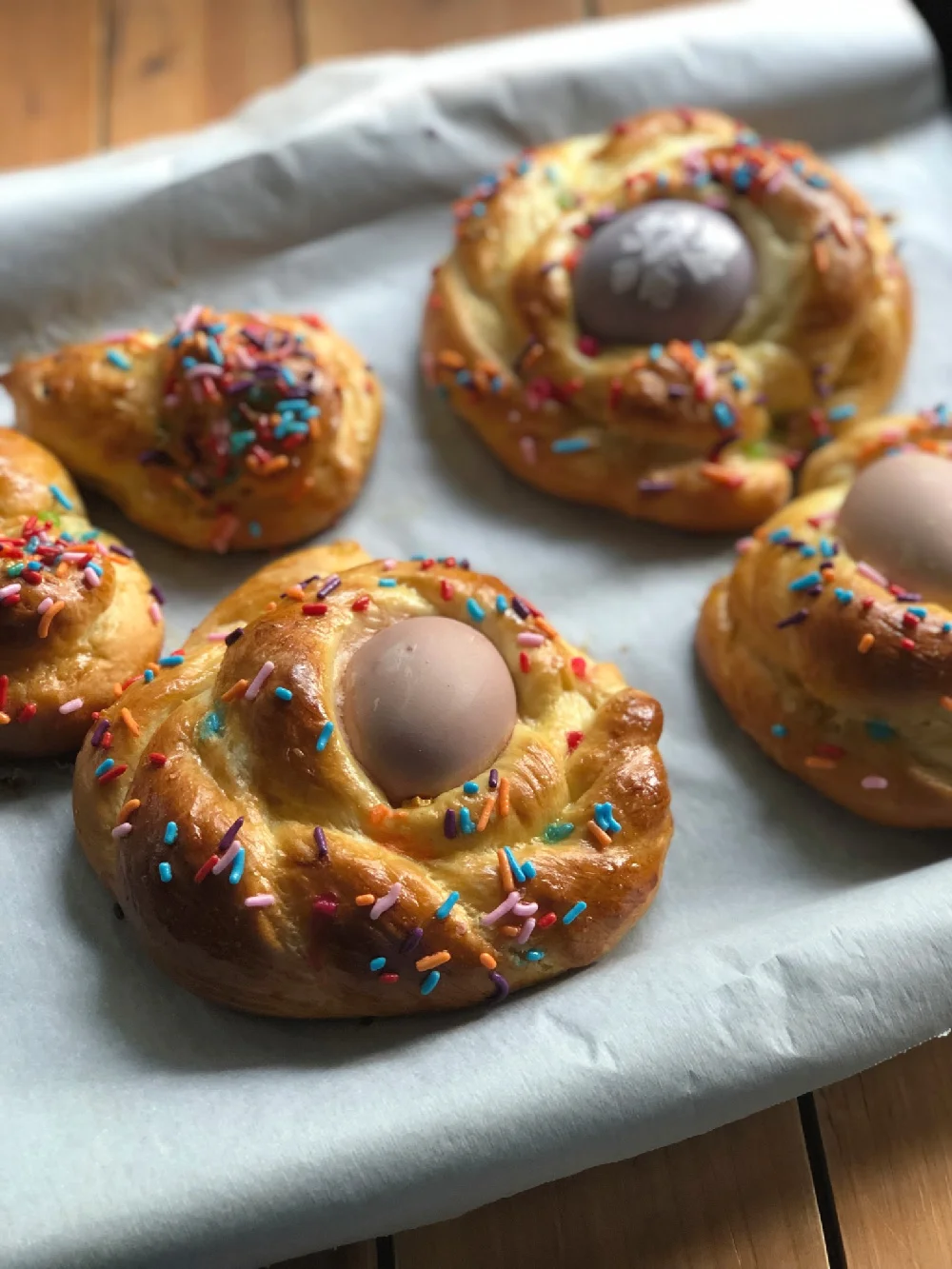 Braided round bread with a colored egg out of the oven