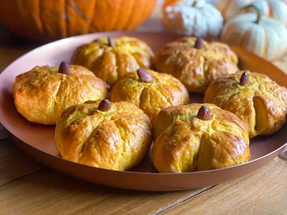 a tray with pumpkin dinner rolls